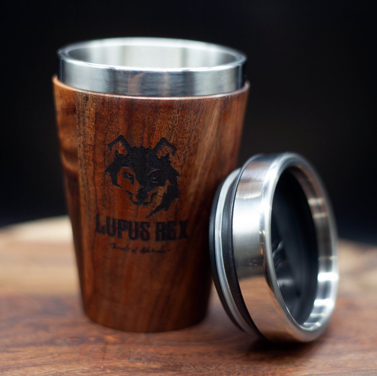 Australian handcrafted mid brown coloured timber exterior travel mug with stainless steel interior. Holds approx. 295ml or 10 oz which is roughly a small to medium at most cafes. Not dishwasher safe. Hand wash only. Don't immerse timber exterior in water. Lupus Rex logo with wolf head branded on timber