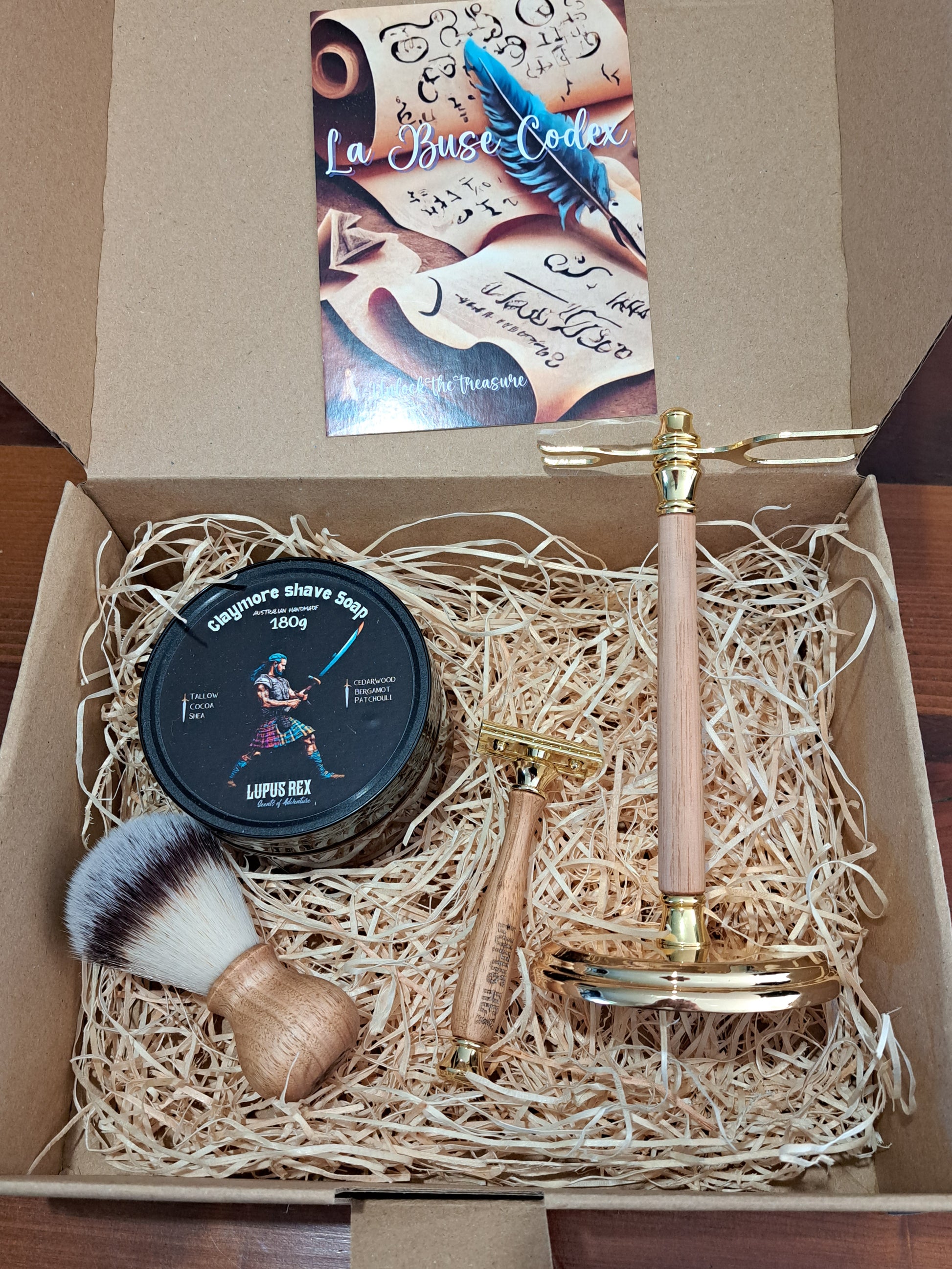 La Buse Codex Gift Box for wet shavers with Australian handcrafted timber handle synthetic shave brush, timber handle razor and timber stand with metal fittings and claymore  tallow based shave soap packaged in a 100% recycled cardboard gift box with wood wool