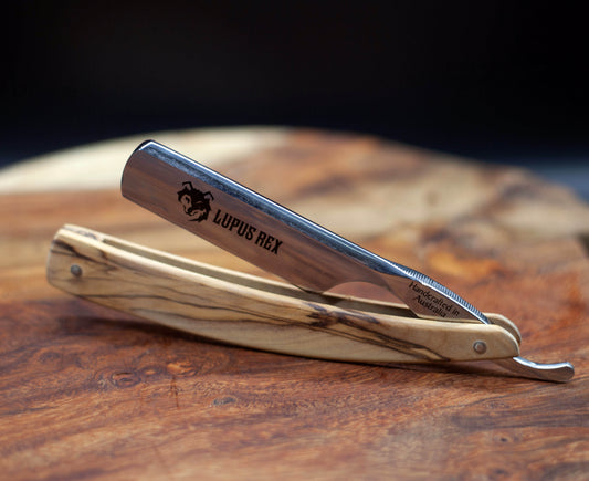 Australian handcrafted straight razor with olive wood timber scales. Lupus Rex and wolf head etched onto the blade with Handcrafted in Australia on the tang