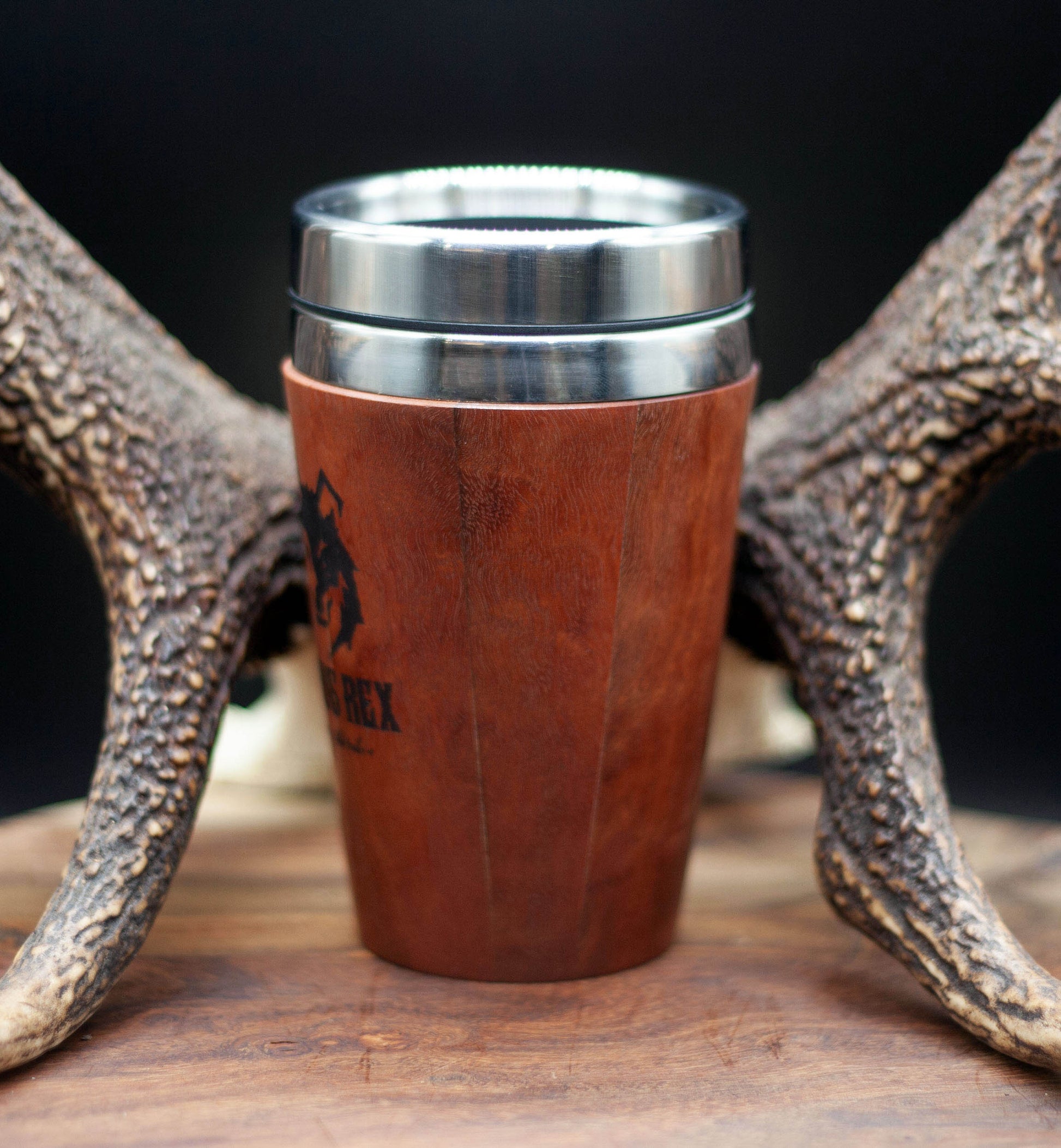 Timber exterior handcrafted travel mug with stainless steel interior. Holds approx. 295ml or 10 oz which is roughly a small to medium at most cafes. Not dishwasher safe. Hand wash only. Don't immerse timber exterior in water. Lupus Rex logo with wolf head branded on  timber