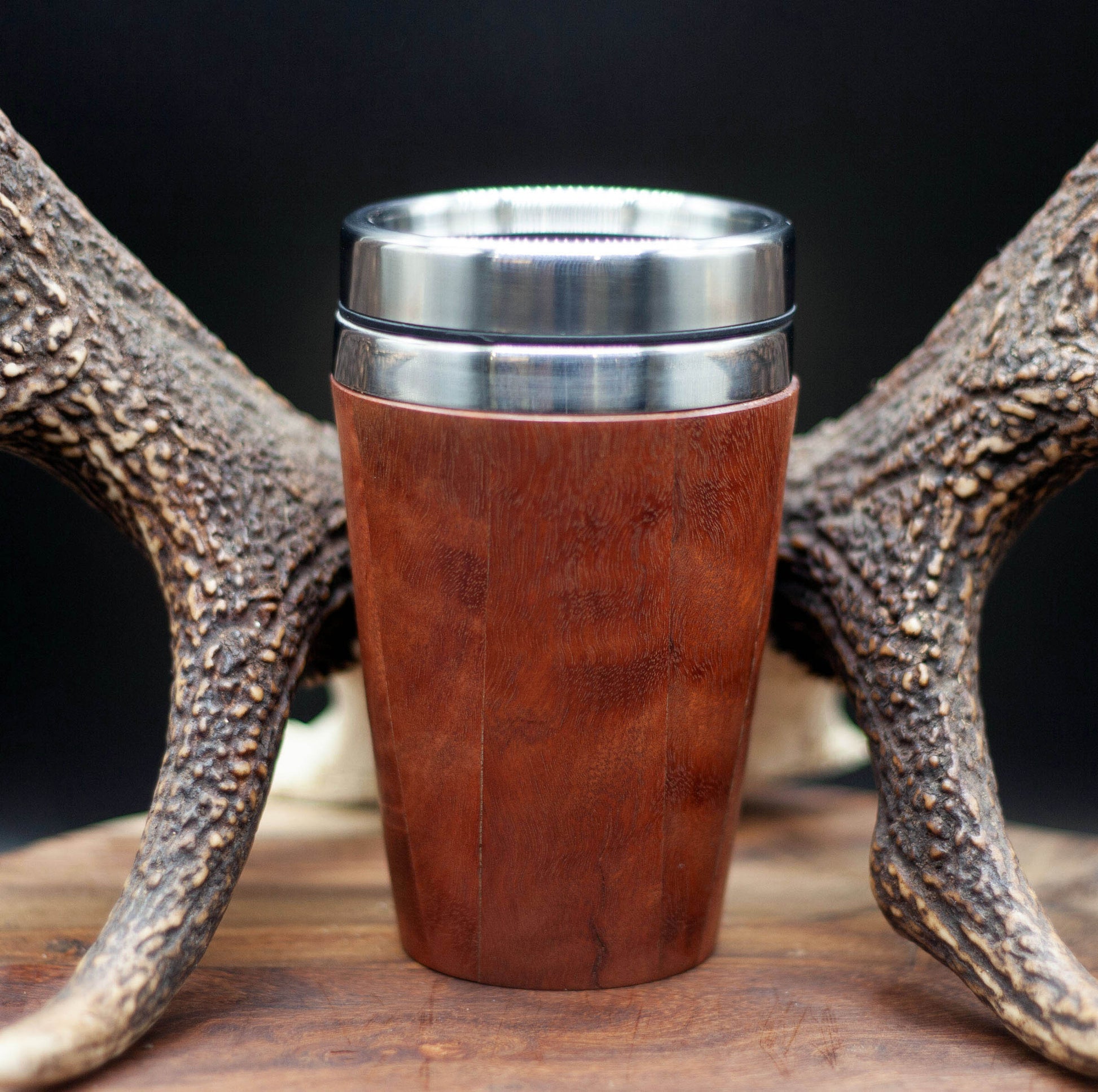 Timber exterior handcrafted travel mug with stainless steel interior. Holds approx. 295ml or 10 oz which is roughly a small to medium at most cafes. Not dishwasher safe. Hand wash only. Don't immerse timber exterior in water. Lupus Rex logo with wolf head branded on  timber