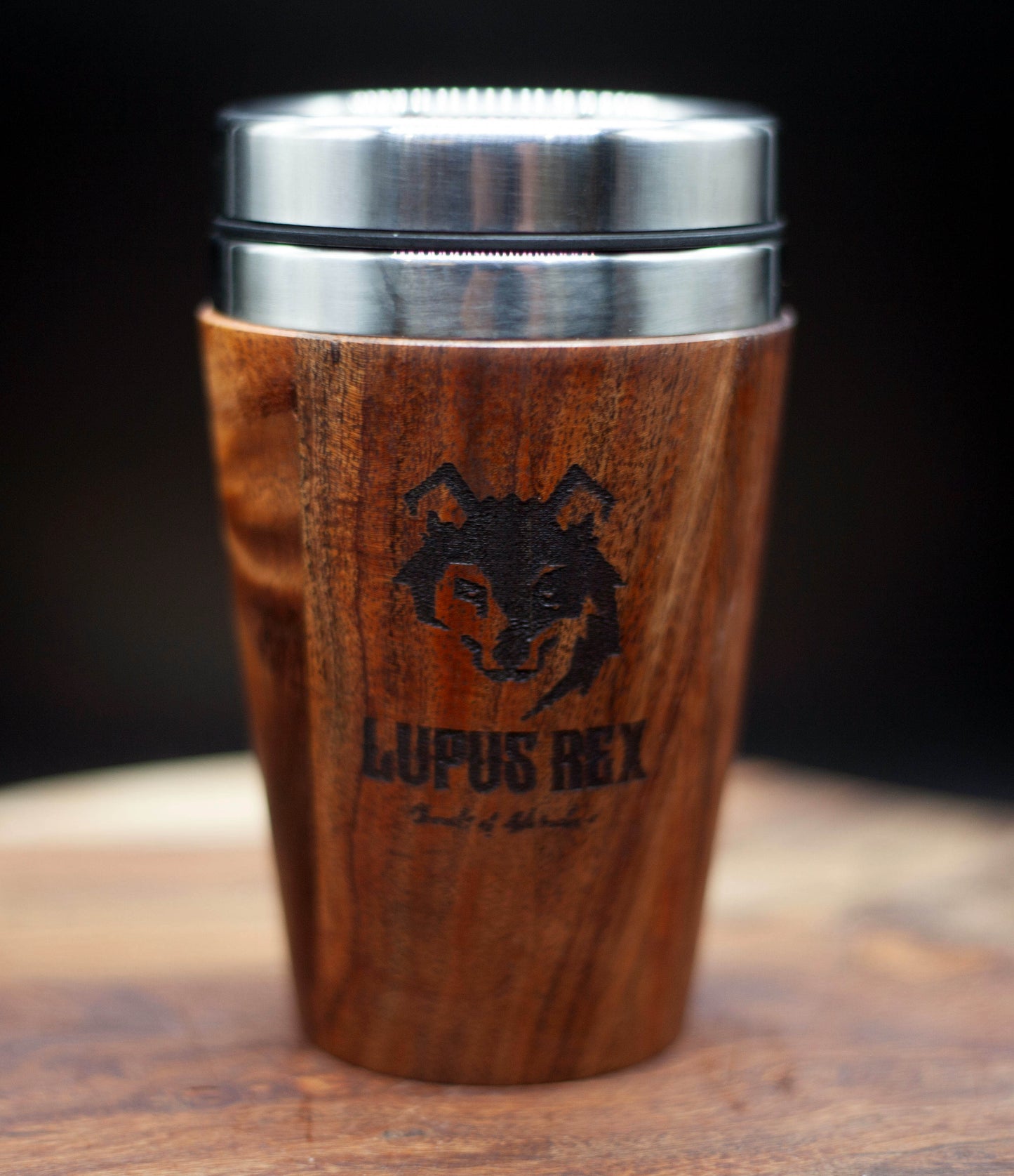 Australian handcrafted mid brown coloured timber exterior travel mug with stainless steel interior. Holds approx. 295ml or 10 oz which is roughly a small to medium at most cafes. Not dishwasher safe. Hand wash only. Don't immerse timber exterior in water. Lupus Rex logo with wolf head branded on  timber